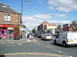 A busy road with shops on both sides