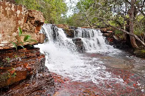 A smaller waterfall over red stone