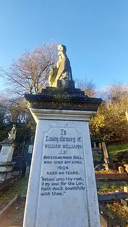a white tombstone bearing an inscription of the death of William Williams in 1904.