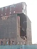 September 17, 2022 Saturday. This view shows the North face the day after demolition crews used a shear to rip apart one of the exposed metal bins.