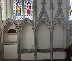 Piscine and sedilia in the St Peter's church at Great Haseley, Oxfordshire, England. March 2025.