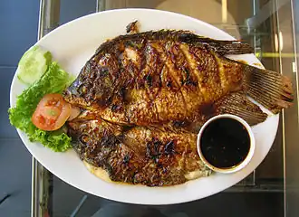 Gurame bakar (grilled gourami) served with sweet soy sauce as both marinade and dipping sauce