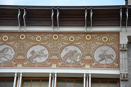 Sgraffito medallions at the top of the façade