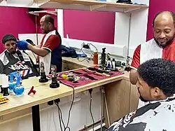 Miguel, the Market Supervisor, gets his haircut at Seven Sisters Market