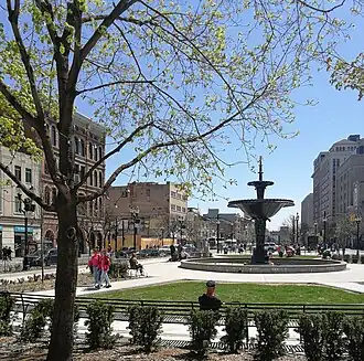 Downtown city park with a water fountain, monuments, and green space