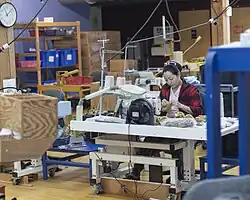 A factory worker performs manual finishing and assembly of teddy bear components at the Vermont Teddy Bear factory in Shelburne, Vermont.