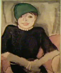 Painting of a woman sitting on a chair. She is smiling and wearing a green hat and red lipstick.
