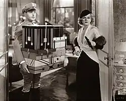 Albert carries an armful of boxes for Lillian