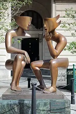 A sculpture depicting two figures in conversation