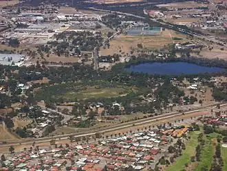 Hazelmere lakes in foreground, Great Eastern Highway Bypass in upper right