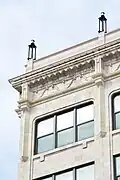 View of the restored cornice and detail work atop the building. (ca. 2025)