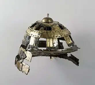 A Kofun period (fifth century) early kabuto made of iron and gilt copper, from Ise Province