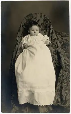 Mother's shape and outline completely hidden by blanket and chair​​‌