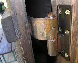 A barrel hinge made of bronze strap