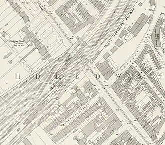 A map of a station from above. The station comprises six parallel tracks with an island platform in the middle, and a massive goods depot to the left. The word "HOLLOWAY" is written across the map, and the line is labelled as the Great Northern Railway