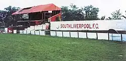 Football pitch and dilapidated grandstand