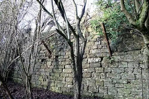 Stone wall with protruding iron bars