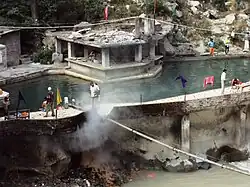 Tourists and pilgrims having a bath in a hot spring