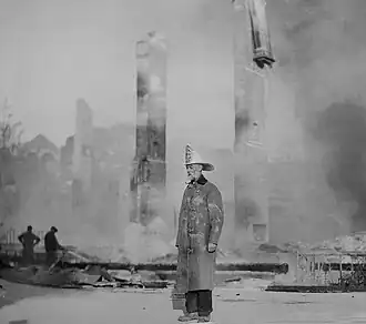 Monterey's first Fire Chief, William "Billy" Parker, stands amid the ruins of the smouldering Hotel Del Monte, September 28, 1924, the second time the hotel burned to the ground.