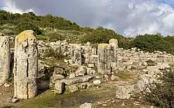 Grooved pillars standing among the ruined walls of the phase II, late Byzantine synagogue
