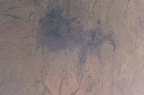 View of the Marrah Mountains from the International Space Station. The landslide took place in the circled area (top of image corresponds to west direction).