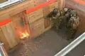 Explosive breaching within a structure, particularly dangerous