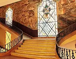 Interior view of the main building showing the stained-glass vitral and central stairway