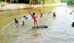 Children swimming nude in the creeks of Ikorodu, Lagos, Nigeria, 2019