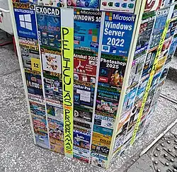 A foam board shows a variety of illicit business software available in the street in Mexico City.