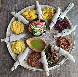 Typical Ethiopian and Eritrean cuisine: Injera (thin pancake-like bread) and several types of wat (stew)