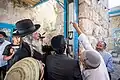 Installing a mezuzah, Tomb of Jesse and Ruth, Hebron
