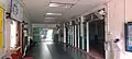 The main hallway of the mosque, with the entrance to the prayer hall visible on the right and the customer service office on the left