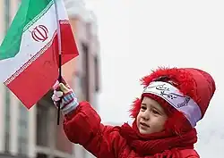 Child with the Islamic flag during the 38th anniversary of the Islamic Revolution