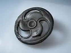 Copper alloy fob with triskele design