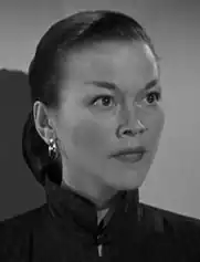 A black-and-white film still depicting Elizabeth Cooper