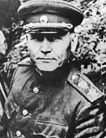 Black and white portrait photograph of a man in a military uniform