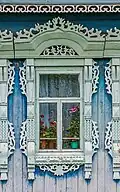 Window with carved platband of the eclectic period. Early 20th century