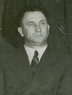 Black-and white image of J. G. Strijdom with a neutral expression at a cabinet meeting