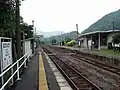 View of the platforms and tracks. Note the level crossing.