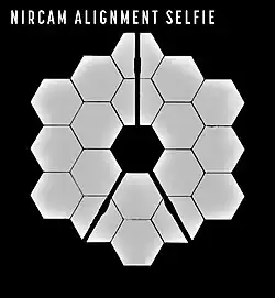 18 primary mirrors of the James Webb Space Telescope reflected in the secondary mirror