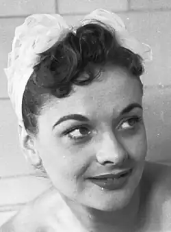 A 23-year-old woman with brown hair smiling to the right.