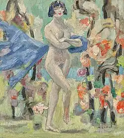 Image of the artist Jacqueline Marval's painting "The Bohemian" from 1921. A nude woman with long white feathers attached to a headband lays on pillows or blankets in a cluttered salon next to a black cat in the foreground on a pink pillow.