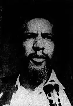 Black-and-white headshot of a bearded Forman