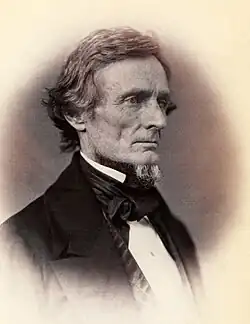 Man with slight beard only on chin in profile looking right