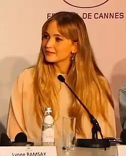 Lawrence glancing to her right and smiling