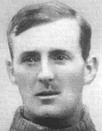 A black and white image of Jerry Dawson posing and staring in front of him