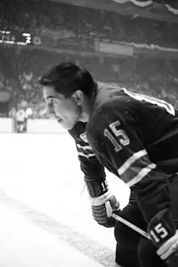 Neilson seen in profile watching something off camera while on the ice in a hockey jersey.