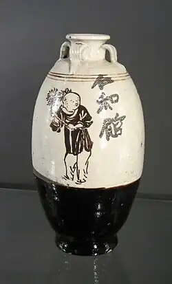 Jin dynasty, iron-pigmented brown slip and cream slip wine bottle with painted boys, inscribed "Benevolence and Harmony Tavern".