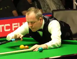 John Higgins playing a shot