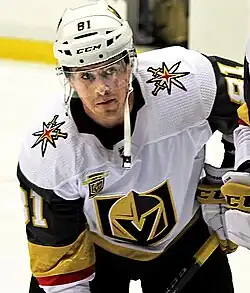 Hockey player in white Vegas Golden Knights hockey jersey during hockey game